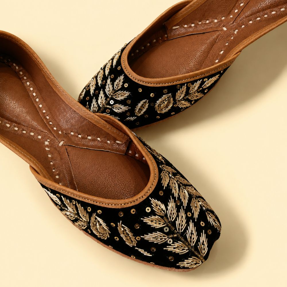 Black Leather Juttis with Golden Botanical Beadwork and Handcrafted Embellishment