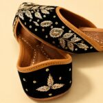 Black Leather Juttis with Golden Botanical Beadwork and Handcrafted Embellishment